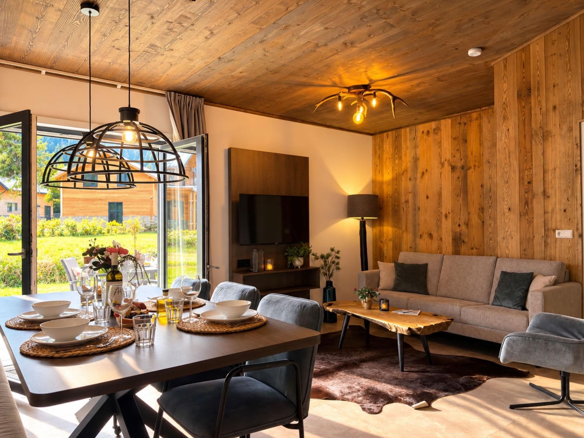 A modern living room with a wooden ceiling, a dining area with a table set for two, and a sofa.