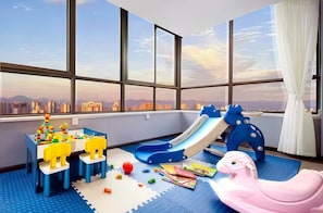 A child's play area with a slide, toys, and a rocking horse. - Chengdu  Yuelanli S Hotel (Chengdu)