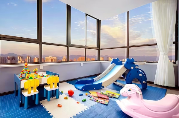 A child's play area with a slide, toys, and a rocking horse. - Chengdu Yuelanli S Hotel (Chengdu)