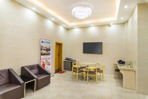A hotel lobby with a chandelier, a flat-screen TV, a reception desk, and a seating area with chairs and a table. - Star Voyage Hotel Shenzhen Airport T3 (Shenzhen)