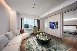 A modern hotel room with a sofa, armchair, and a bed. - Mehood Elegant Intl. Nanhai Guangfo (Foshan)