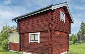 A red wooden cabin with a gabled roof, two windows, and a small porch area. - 1 bedroom lovely home in Leksand (Leksand)
