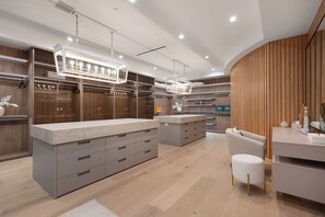 A modern bathroom with a large vanity, built-in shelves, and a wooden accent wall. - Somera Masterpiece (Los Angeles)