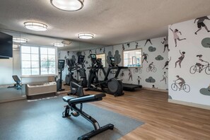 A gym with exercise equipment, large windows, and a mirror. - Modern Urban Retreat | Free Parking | Near Buffalo Ridge Park - 1.6 miles (Fort Worth)