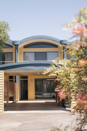 A modern two-story building with a covered entrance, large windows, and a visible number '6' on the facade. - Halls Gap Escape Townhouse 6 (Halls Gap)