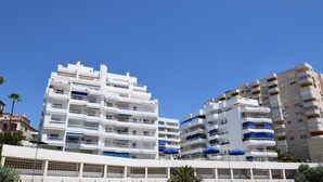 A multi-story building with balconies and a flat roof. - Coastal Living Near Estepona Marina (Estepona)