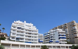 A multi-story building with balconies and a flat roof. - Coastal Living Near Estepona Marina (Estepona)