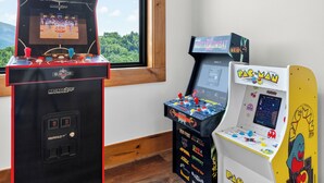 Tre arkadspel, varav ett är märkt med «Mortal Kombat», ett annat med «Pac-Man» och det tredje med «Arcade 2Up».