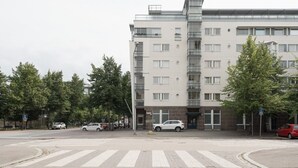 Monikerroksinen rakennus, jossa on moderni arkkitehtoninen ilme, ja jonka tunnusomaisia piirteitä ovat näyttävä lasijulkisivu ja useat parvekkeet.