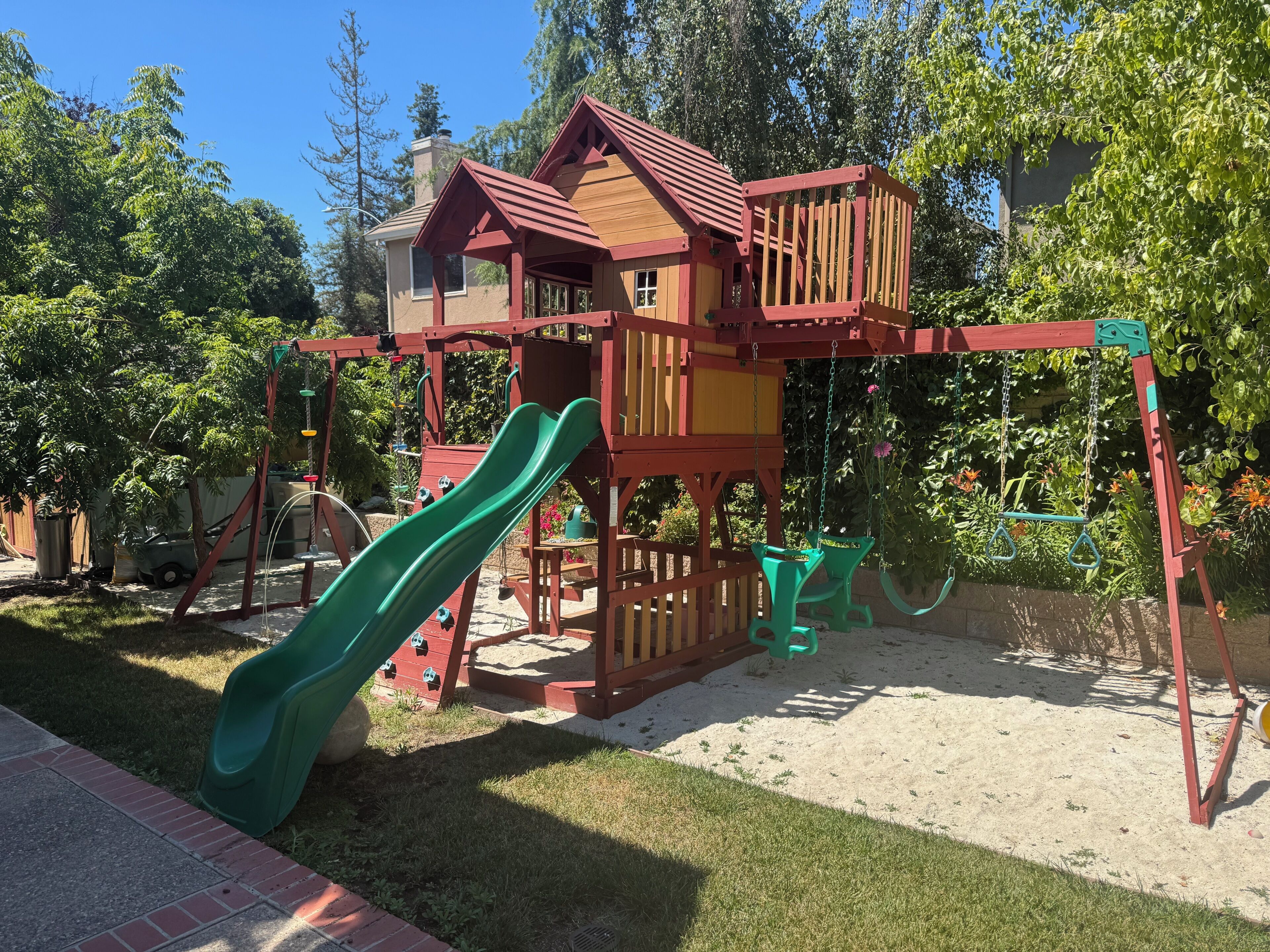 A playground with a slide and climbing structures.