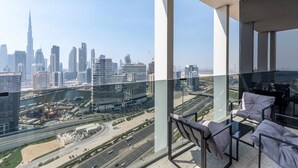 A balcony with a city view, including a prominent skyscraper. - Contemporary Studio w/ Burj View (Dubai)