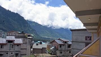 Zona residencial con edificios, montañas al fondo y cielo despejado.
