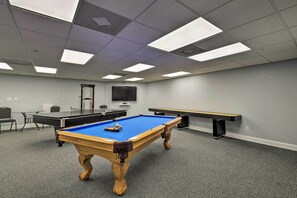 A room with a pool table, a billiards table, and a seating area with chairs. - Pool, Pickleball & Beach! Gulf Island Club Condo (Hudson)