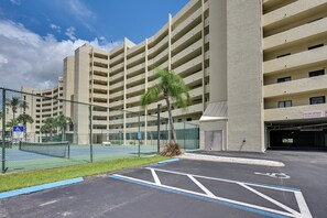A multi-story parking garage with a clear sky.