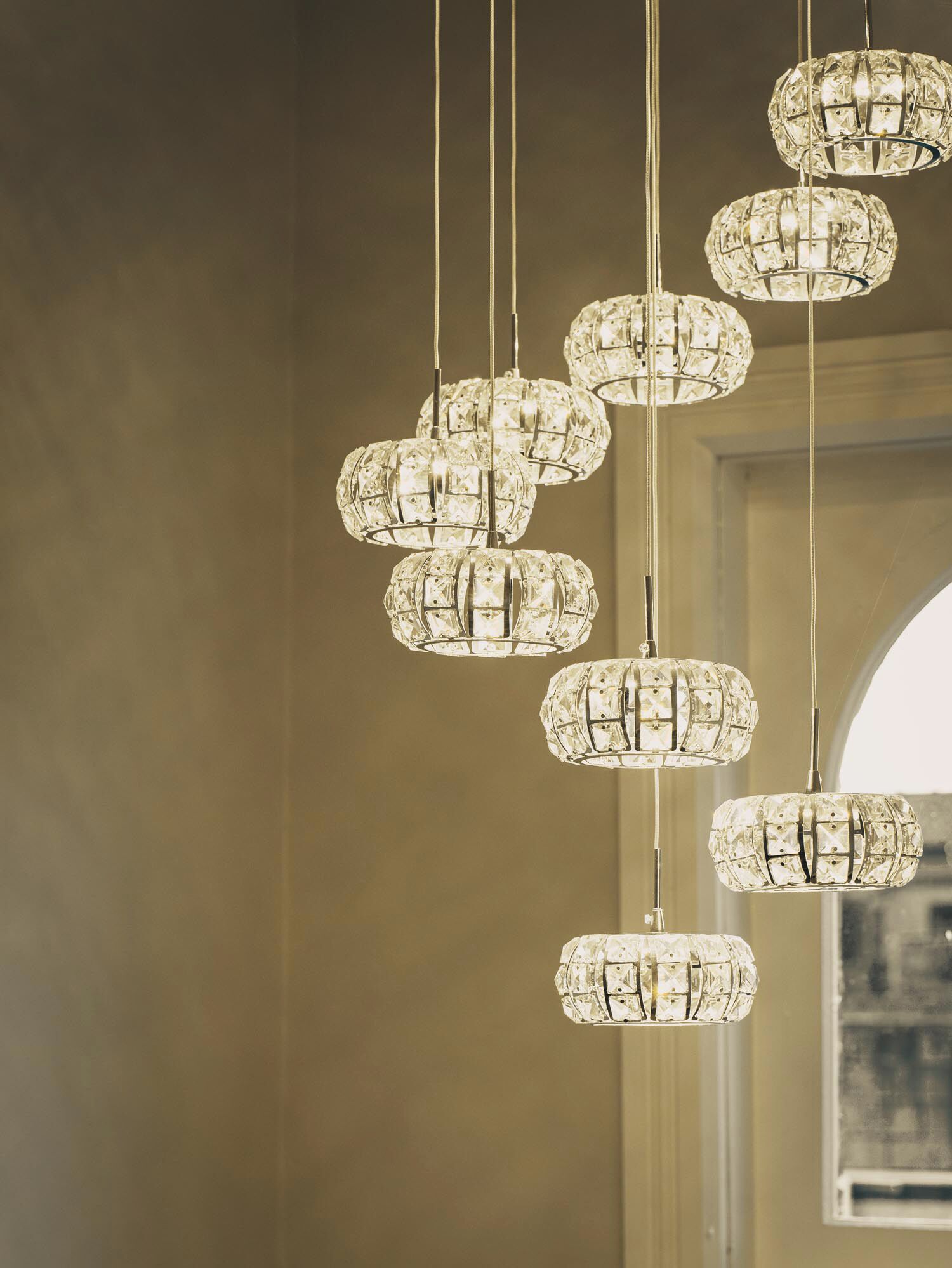 A chandelier with multiple crystal elements suspended from the ceiling.