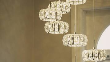 A chandelier with multiple crystal elements suspended from the ceiling.
