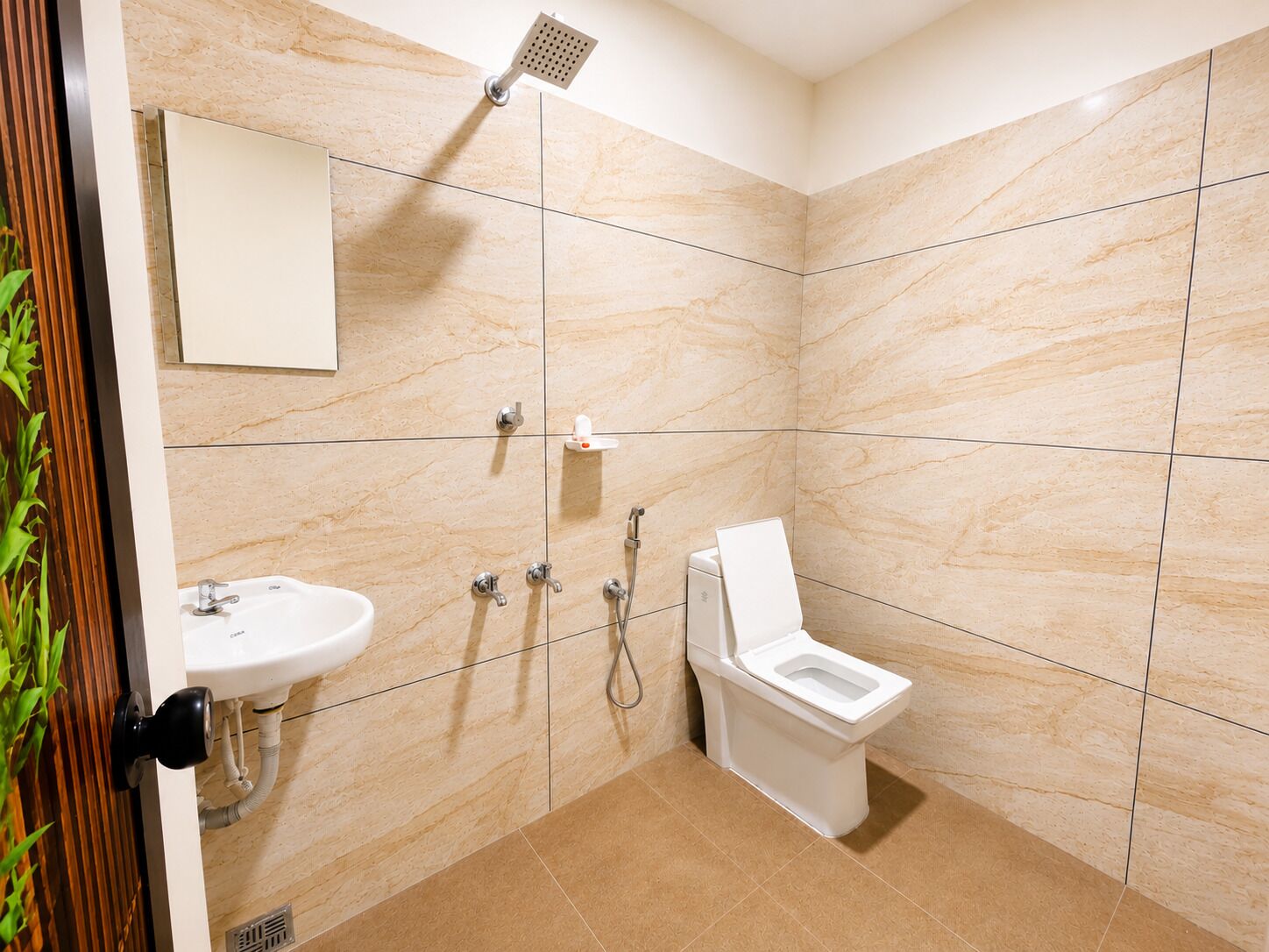 A modern bathroom with a shower, toilet, and sink.
