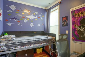 A child's bedroom with a bunk bed, wall decals of fish and sharks, a poster of a movie, and a window with curtains. - Quiet Home in Walkable Area: 3 Mi to National Mall (Washington)