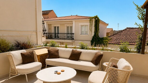 A terrace with a sofa set, a round table, and wicker chairs. - Meros Marotti | Spacious 3BR Home in Zakynthos (Zakinthos)