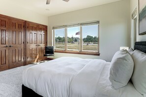 A bedroom with a large bed, a wooden wardrobe, and a window with a view of the outside. - Mtn Getaway Near Air Force Academy w/ Hot Tub (Colorado Springs)