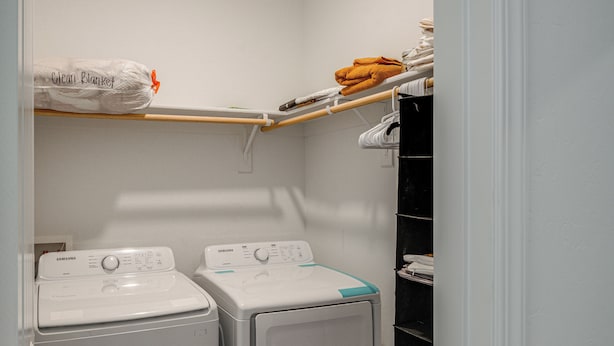 A laundry room with two front-loading washing machines and a shelf with towels and a plastic bag labeled 'Clean Blanket'. - 1BR Guest House w/ Private Entrance and Laundry (Bakersfield)