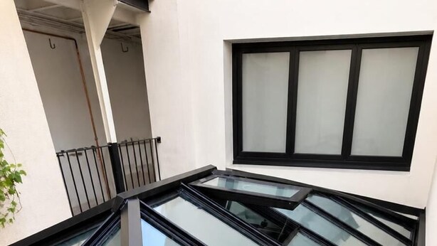 Un bâtiment moderne doté d’une structure de toit en verre.