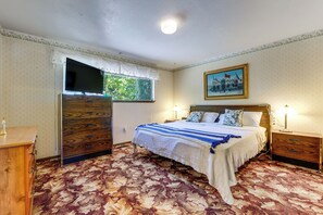 A bedroom with a bed, a nightstand, a dresser, a television, and a window. - Private Yard & Patio! Pet-Friendly Lynnwood Home (Lynnwood)
