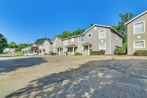 A row of townhouses with a driveway and a parked car.