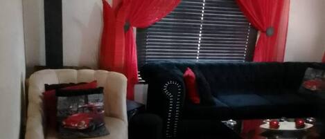 A living room with a sofa, a chair, and a coffee table.
