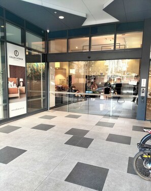 A hotel entrance with a glass door, a sign for Cdluxe Interior Australia, and a tiled floor. - 2 Bedroom• 2Bath• Fortitude Valley -Free WIFI (Brisbane City)