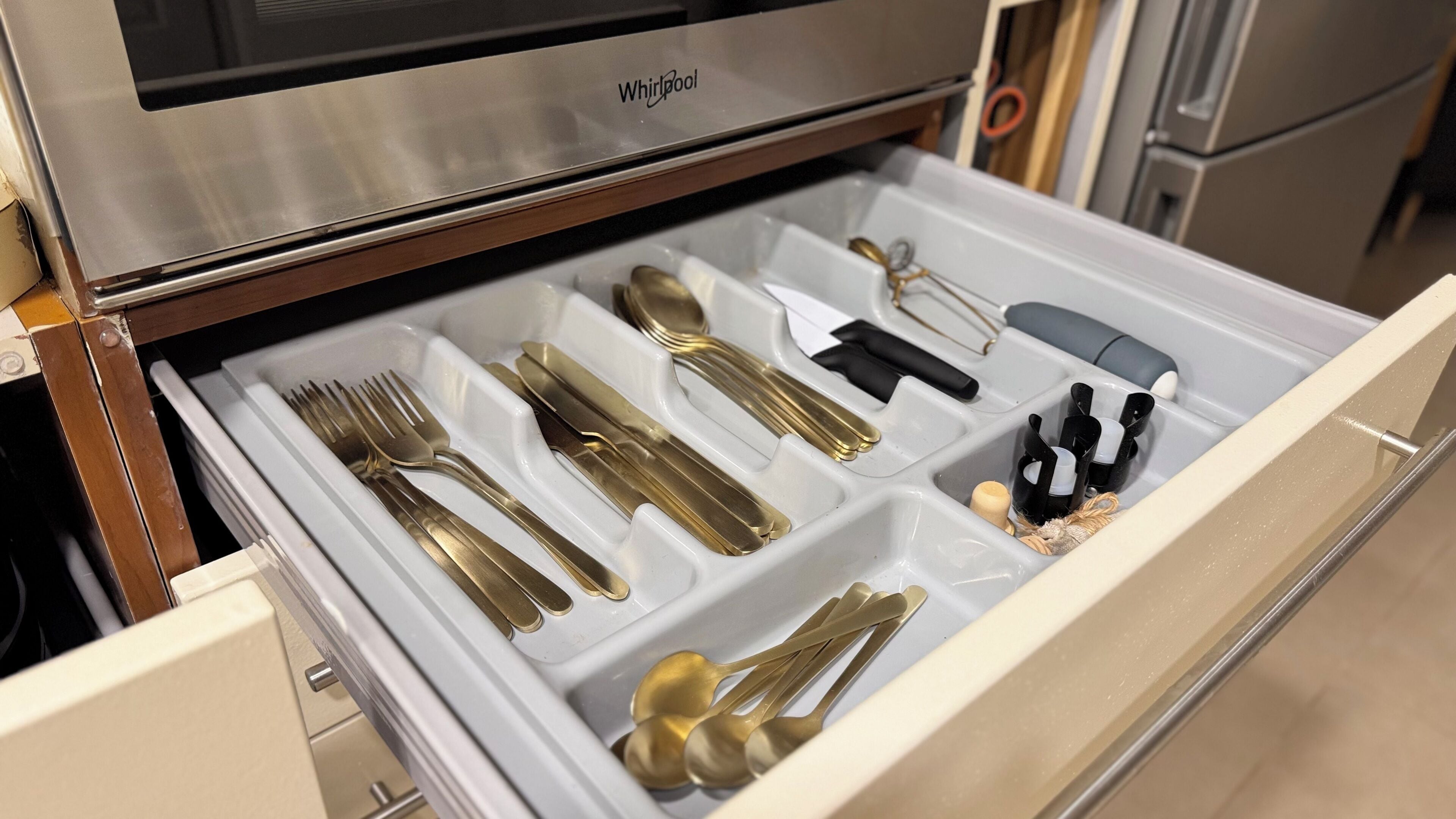 A drawer with neatly arranged cutlery including forks, knives, and spoons.