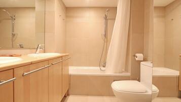 A modern bathroom with a shower, toilet, and vanity.