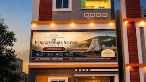 A multi-story hotel with a prominent sign advertising a homestay experience. - Sri Venkateswara Nilayam Home Stay (Tirupati)