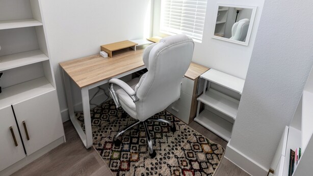 A modern office space with a desk, chair, and shelving units. - Luxurious 3-Bedroom Home In Downtown Houston Area (Houston)