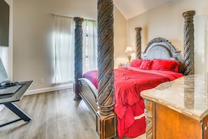 A bedroom with a four-poster bed, a desk with a computer, and a marble side table. - Walk to Shops & Dining! Quiet Fultondale Home (Fultondale)