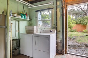 A laundry room with a washing machine, a drying rack, and a window overlooking a backyard. - Walk to Beaches! Lincoln City Family Home w/ Yard (Lincoln City)