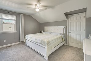 A bedroom with a bed, a ceiling fan, a window with blinds, and a door. - Spacious Sinking Spring Home w/ Outdoor Oasis! (Sinking Spring)