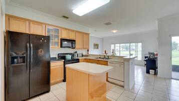 A modern kitchen with a refrigerator, stove, microwave, and dishwasher.