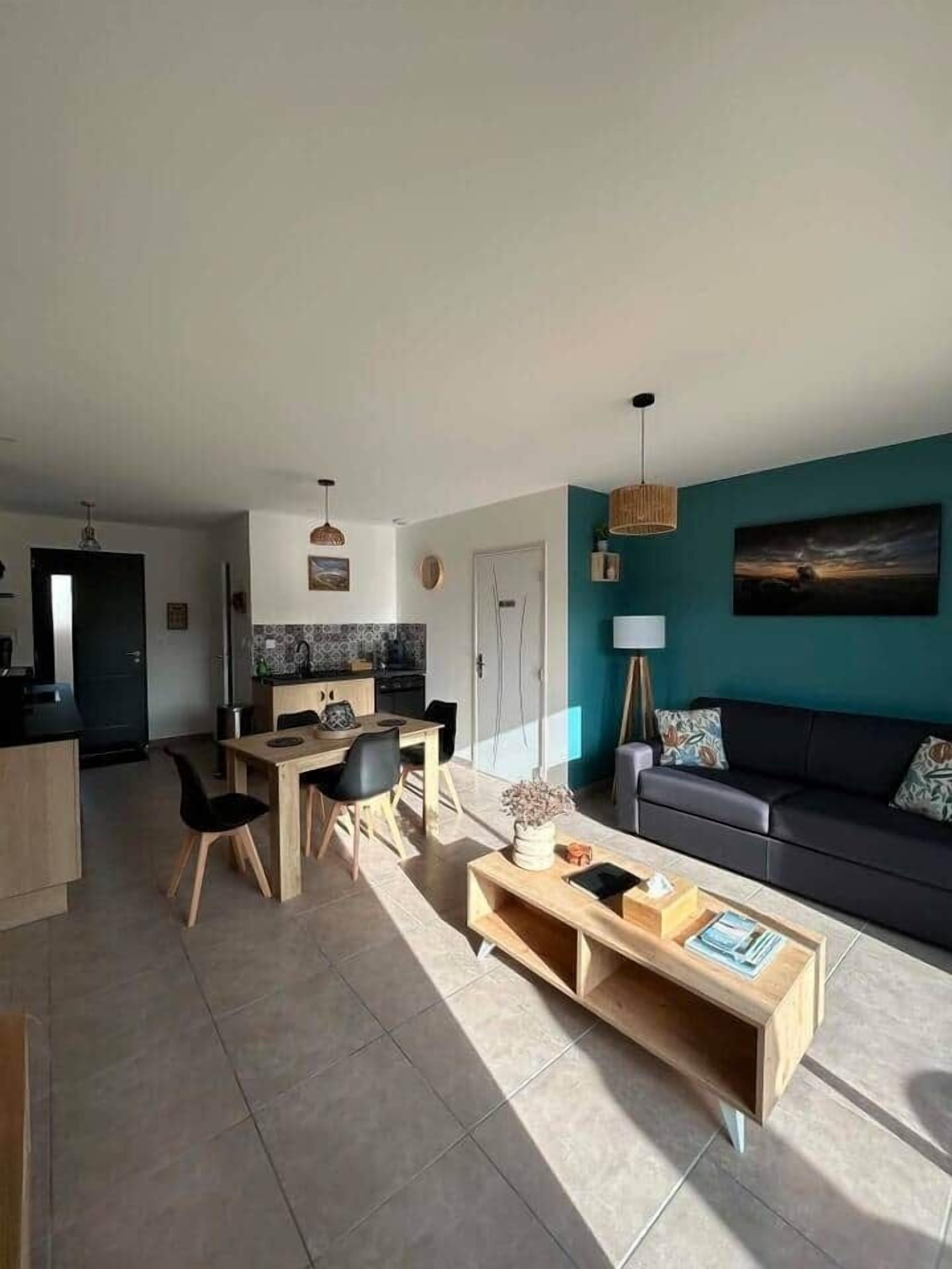 A modern living room with a dining area, a sofa, and a coffee table.