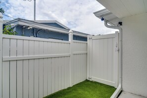 A white wooden fence with a small grassy area in front. - Work & Relax in Safety Harbor! Modern Coastal Apt (Safety Harbor)
