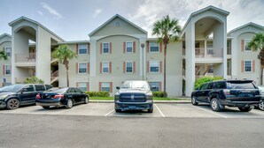 A multi-story residential building with a parking lot in front. - Walk to Shops & Eats! Cape Coral Extended Escape (Cape Coral)