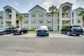 A multi-story residential building with a parking lot in front. - Walk to Shops & Eats! Cape Coral Extended Escape (Cape Coral)