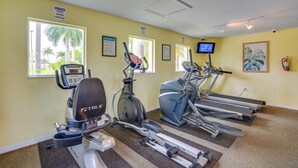 A fitness center with treadmills, an elliptical, and a stationary bike, all equipped with digital displays. - Walk to Shops & Eats! Cape Coral Extended Escape (Cape Coral)