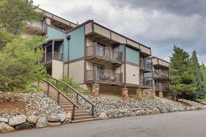 A multi-story building with balconies, a stone staircase, and a rocky landscape. - Hike, Bike & Ski! Cozy Condo 8 Mi to Lake Dillon (Breckenridge)