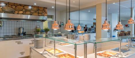 A buffet area with glass display cases and copper pendant lighting.