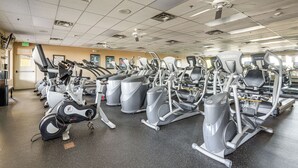A gym with multiple cardio machines, a ceiling fan, and a door labeled 'EXIT'. - Complimentary Golf Cart! Viewpoint Resort Home (Mesa)