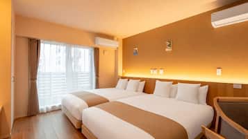A hotel room with two beds, a wooden floor, an air conditioning unit, and a view of the outside.