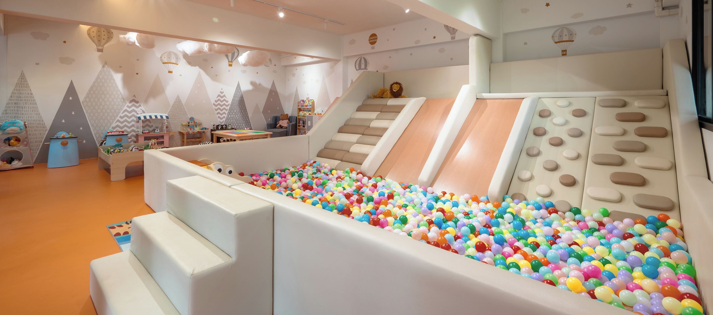 A children's play area with a ball pit, slides, and climbing structures.