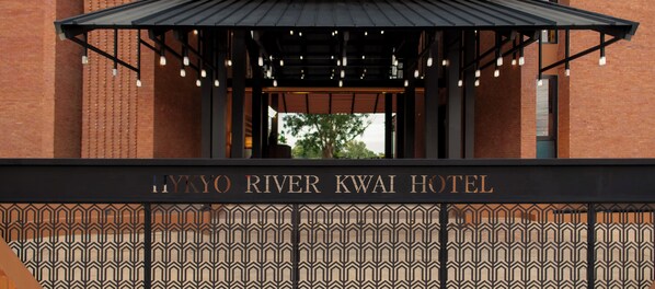 The entrance to the Hyogo River Kwai Hotel with a patterned facade and a covered entrance area.