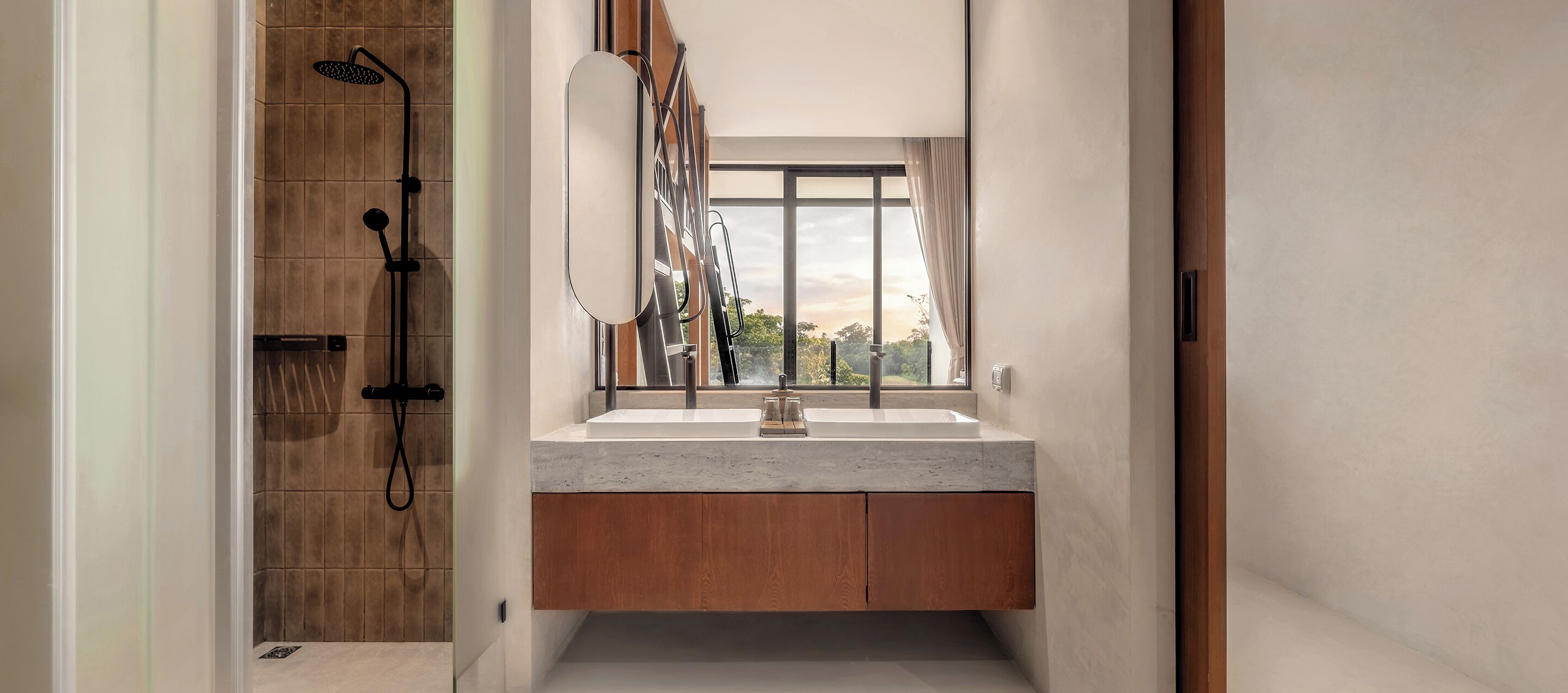 A modern bathroom with a shower, a large mirror, and a window.